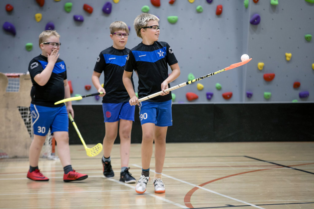 Boys playing floor ball.